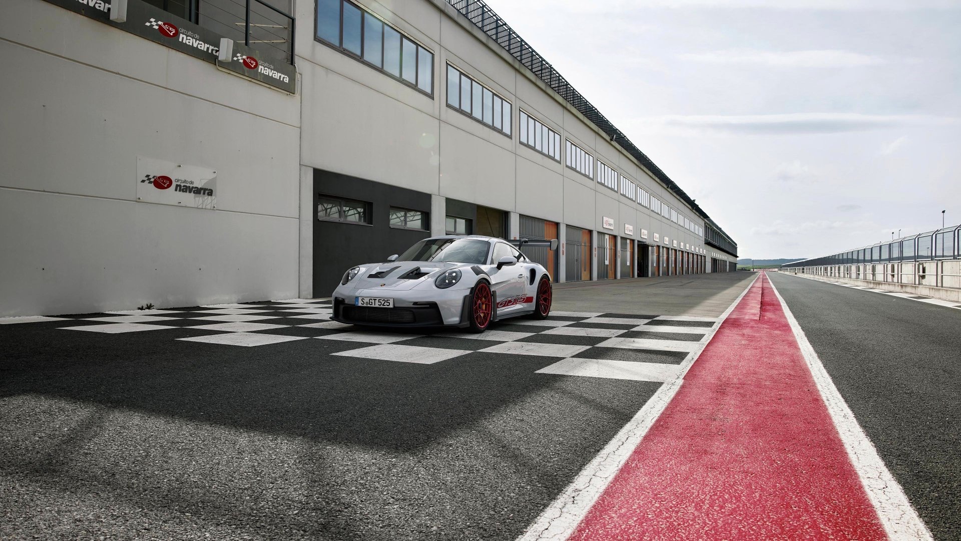 A GT3 car waiting in the pit lane at a racing circuit